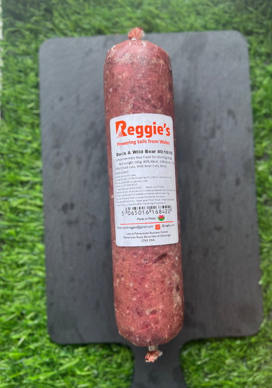 Roll of 500g raw dog food on a slate with a grass background